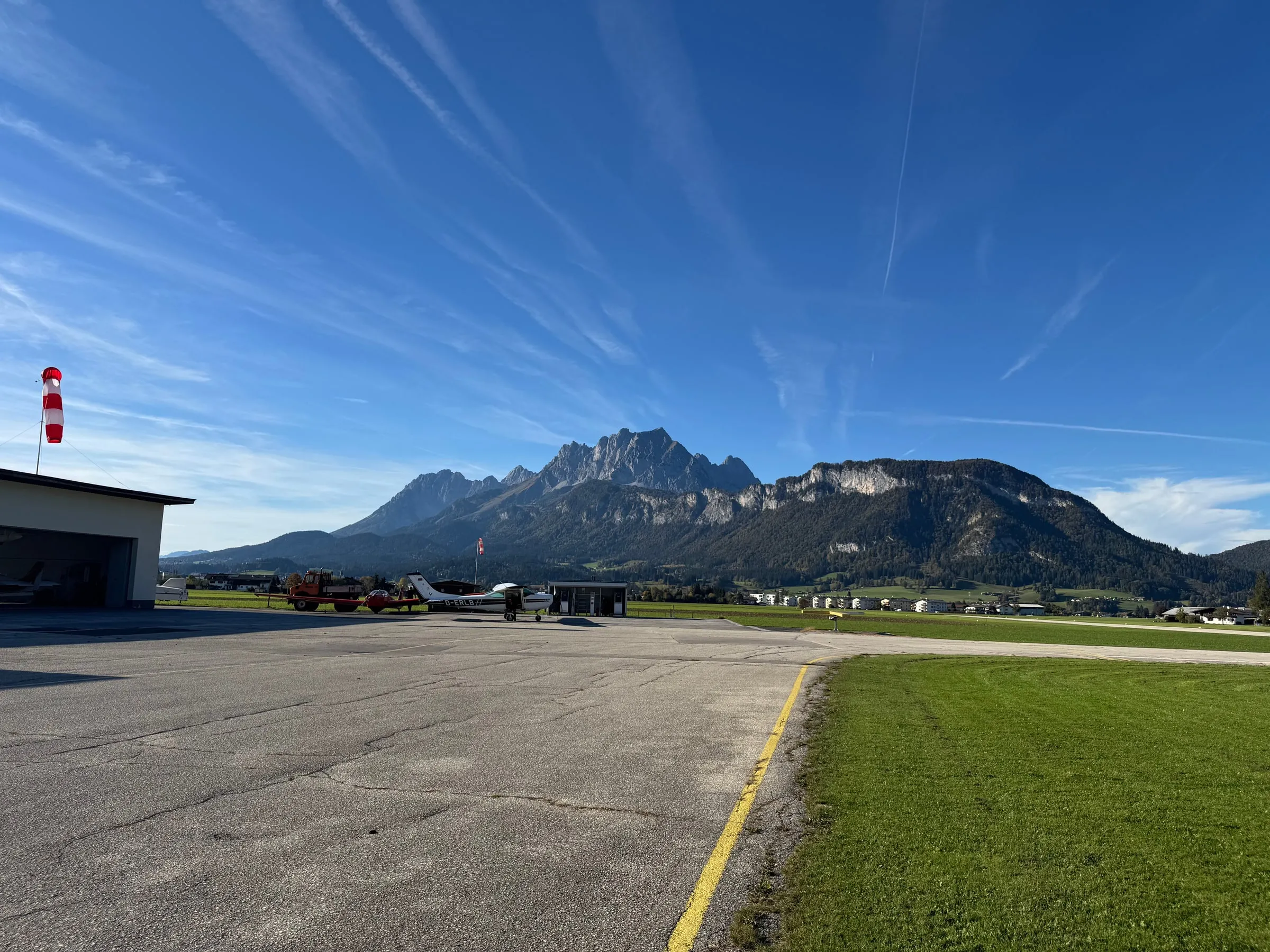 St. Johann airfield apron and windsock with mountains beyond